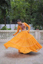 Banjara India Faux Georgette Bandhej Print with Gotta Patti Lace Work  Long Flair Lehenga Set - Mango